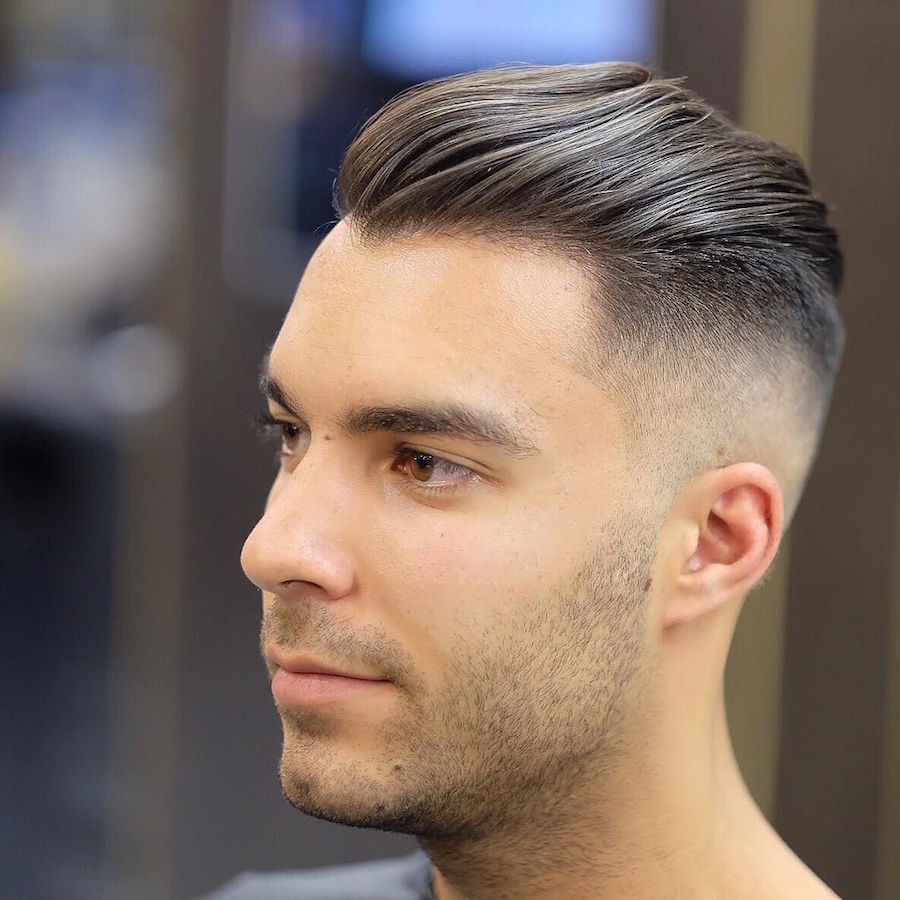 High fade slicked back medium length men's hairstyle