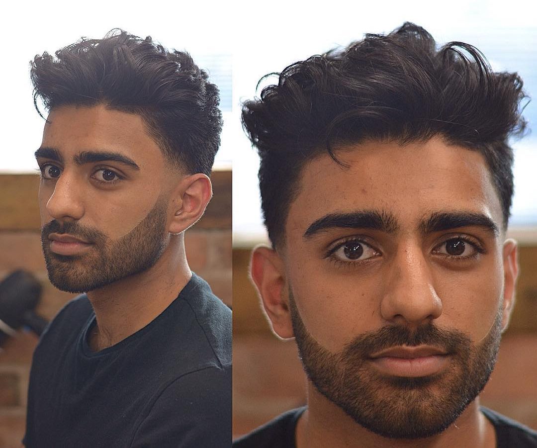 A picture of a male hipster with a long side swept undercut hairstyle for  his green curly hair which he also has it trimmed in a layered haircut -  Long Hair Guys
