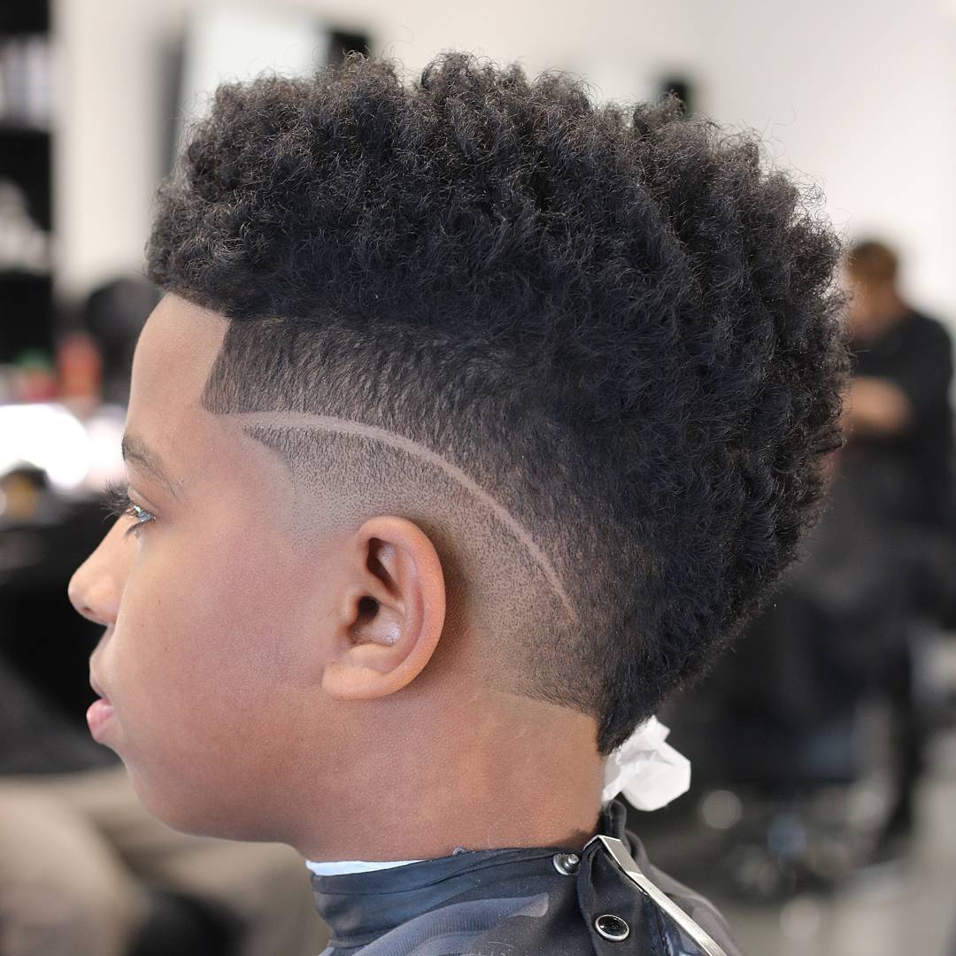 Black boy with a curly mohawk haircut
