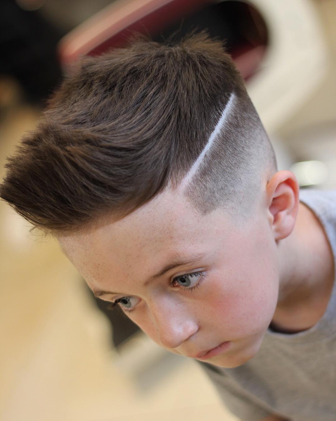 Quiff haircut for boys with a high skin fade