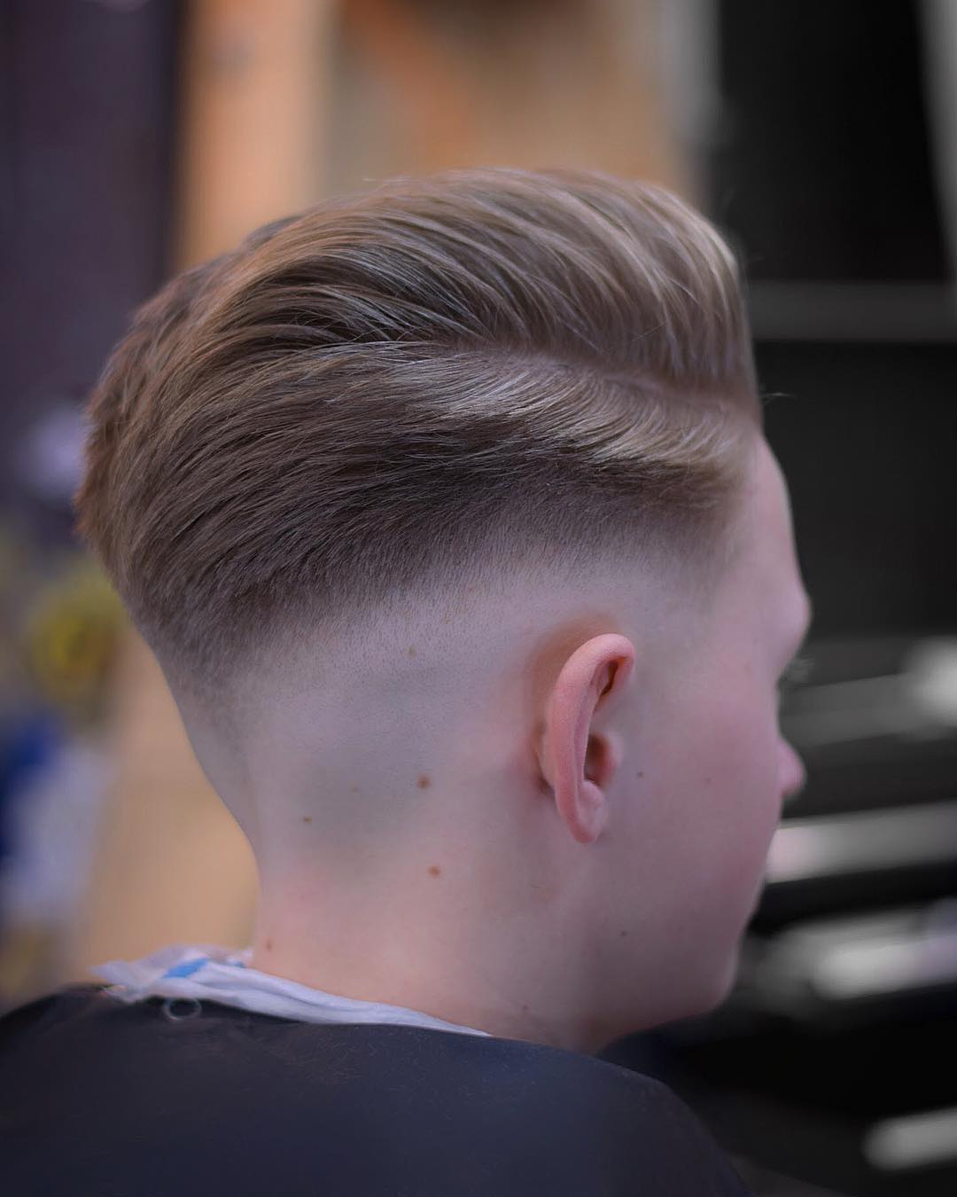 Side part haircut and a low fade