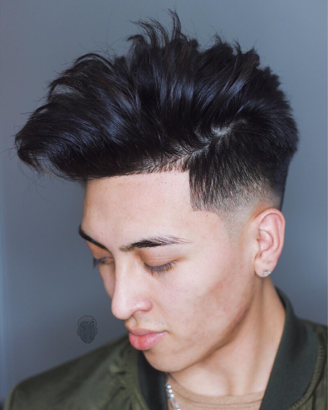 Messy pompadour hairstyle low bald fade