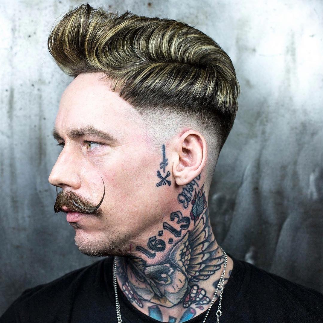 Side part pompadour quiff hairstyle for men and low bald fade