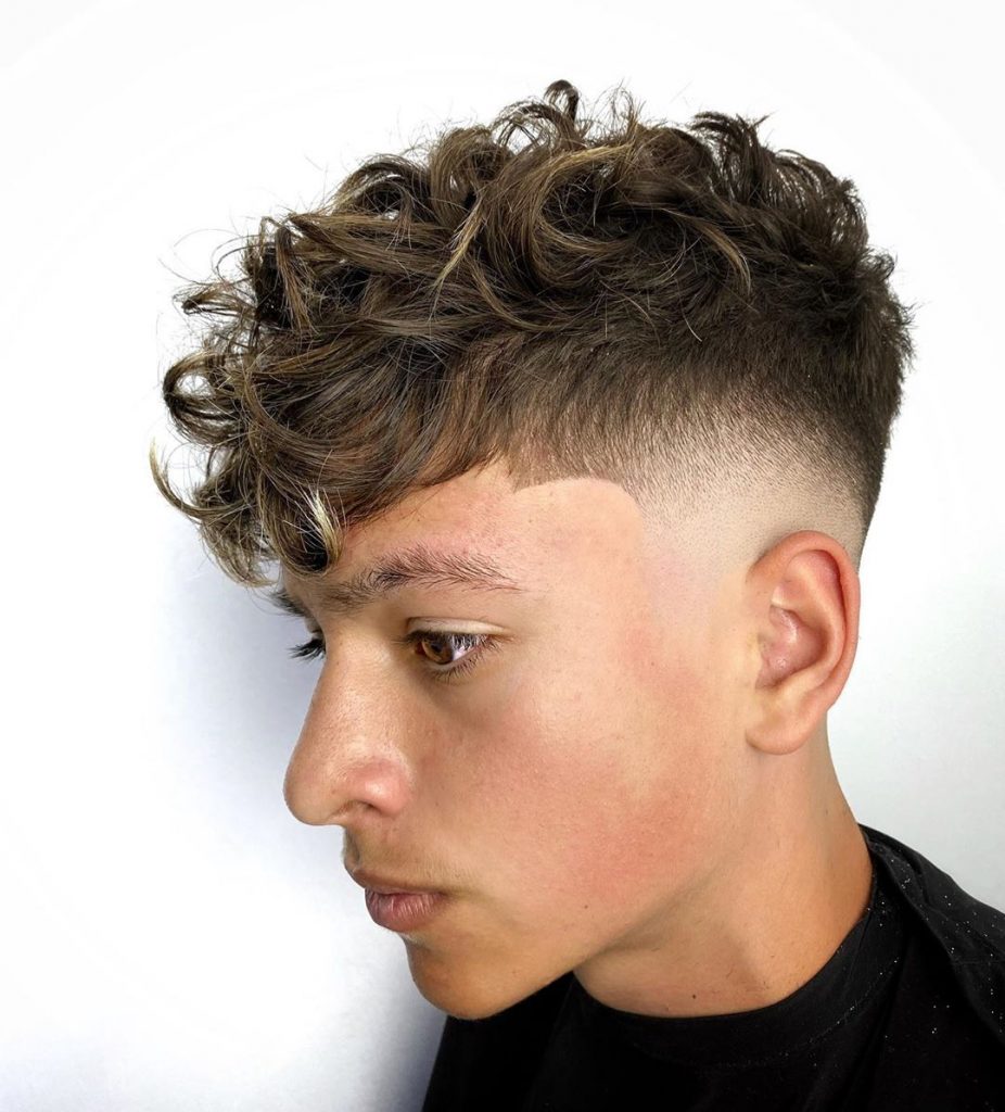 Fade haircut with curly hair on top