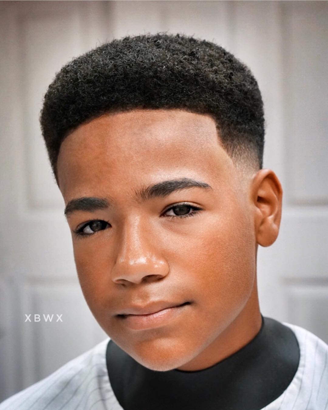 Short natural curls with low fade