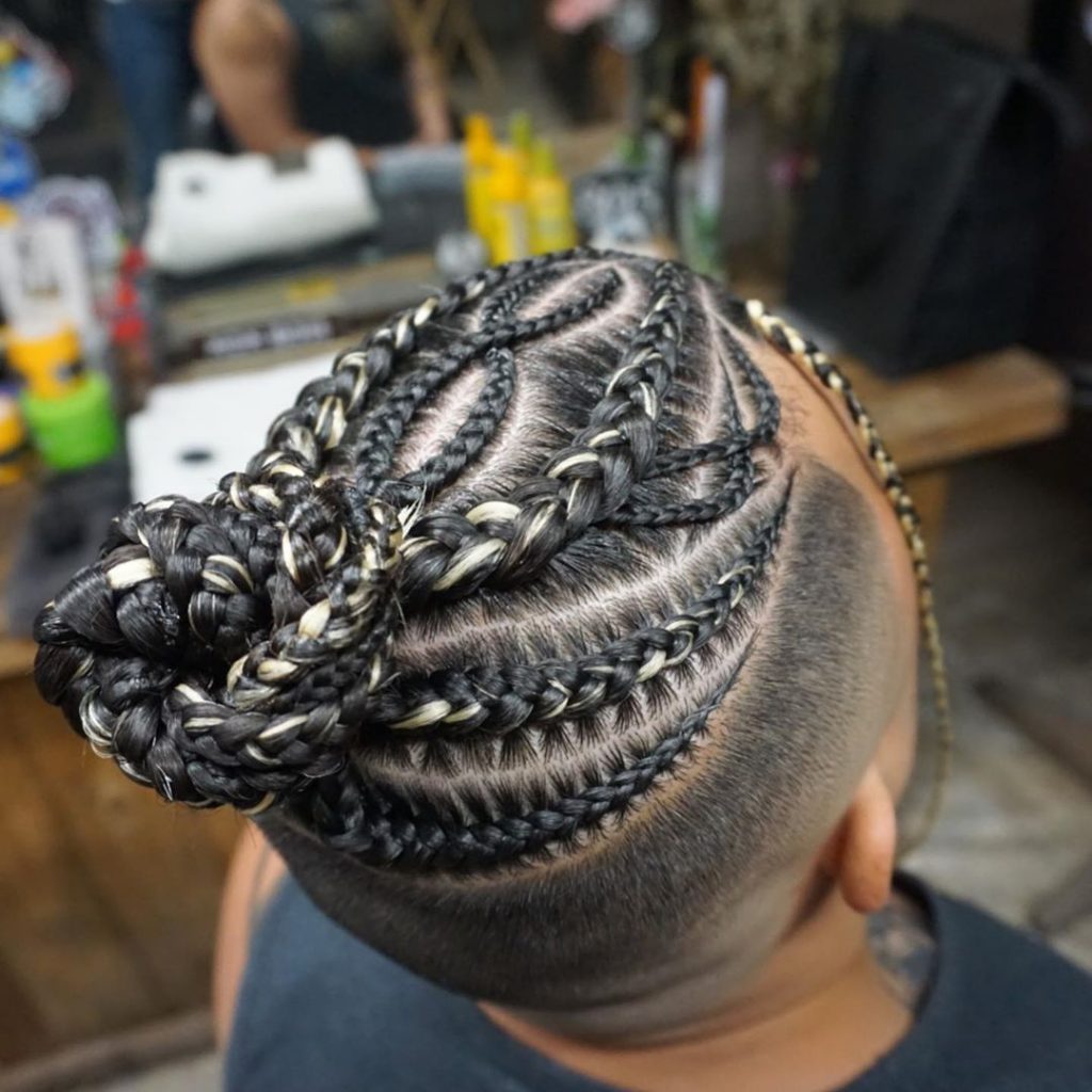 Braided man bun with shaved sides 