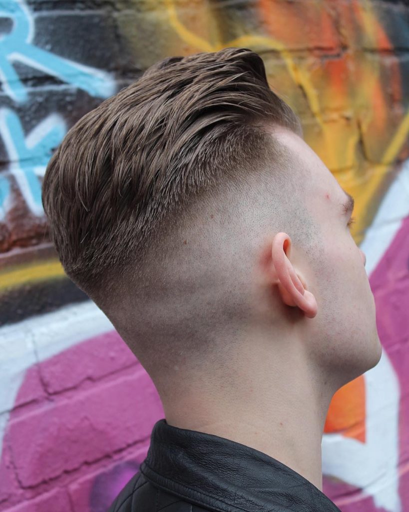 The back of the head of a boy with lush hair on the crown Closeup of a  hairstyle on a childs head Back view of the hairstyle of a man with a