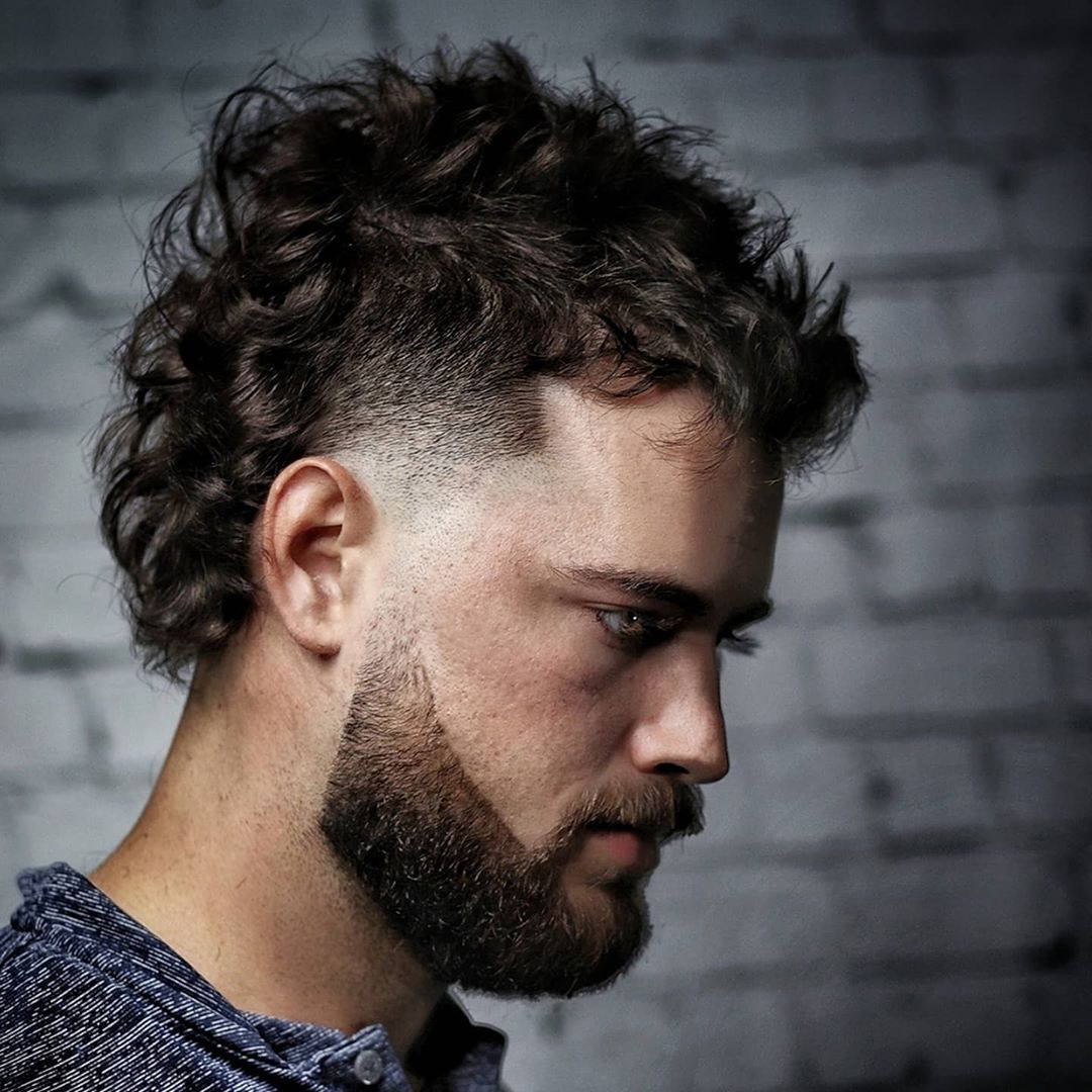 Curly mullet haircut with temp fade and beard