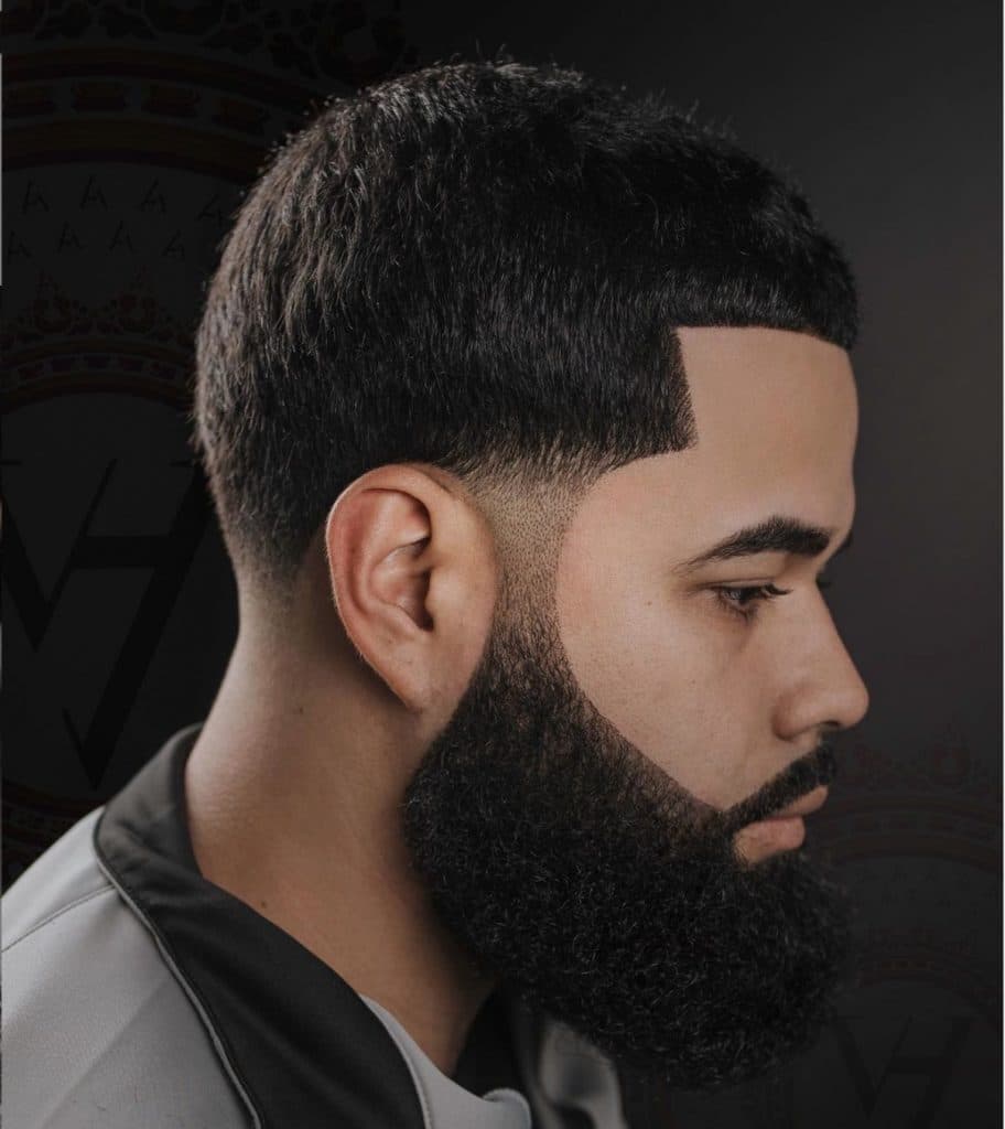 Low taper fade haircut with long beard