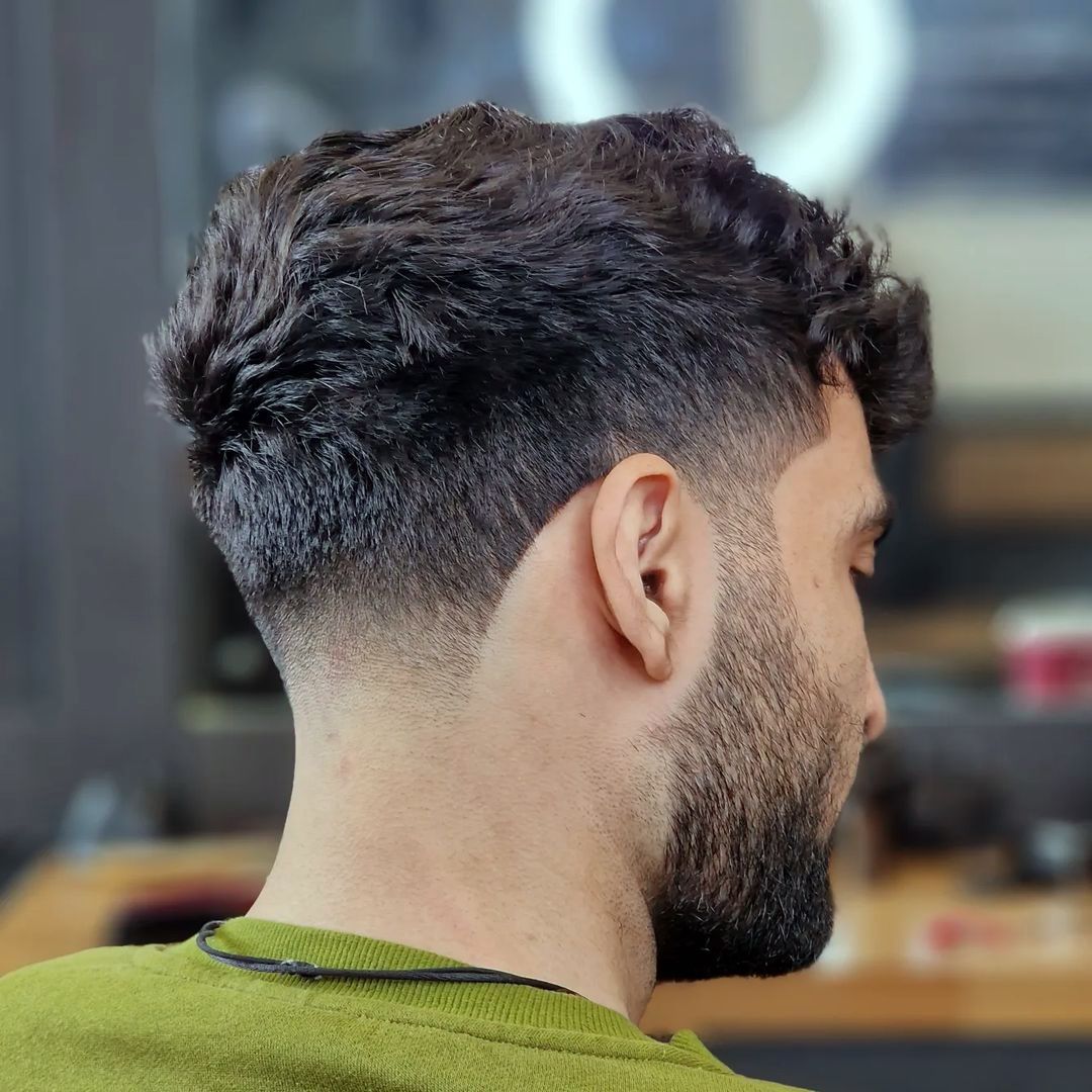 Medium-high taper fade for thick curly hair
