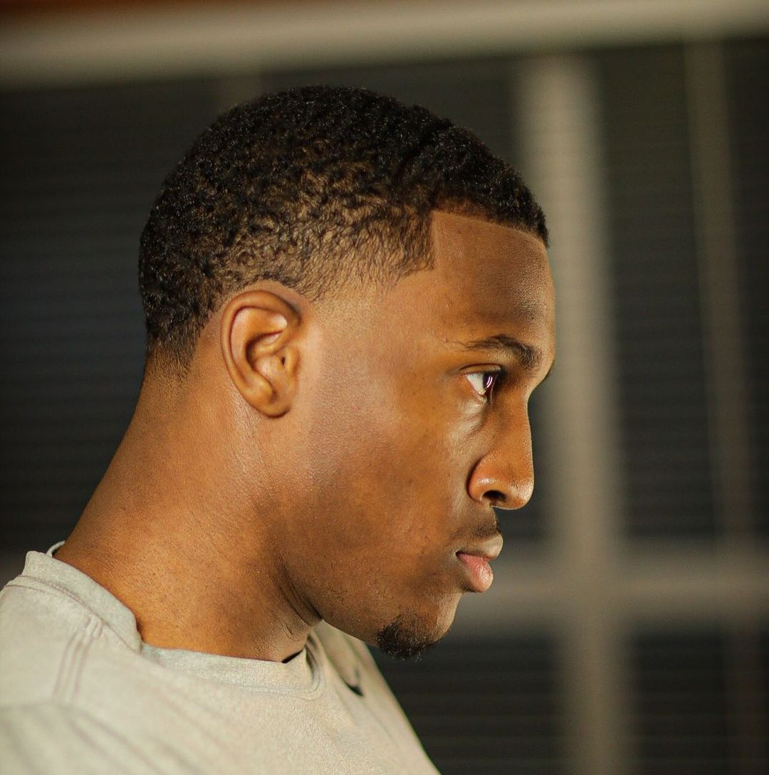 Short curly haircuts for Black men with taper fade
