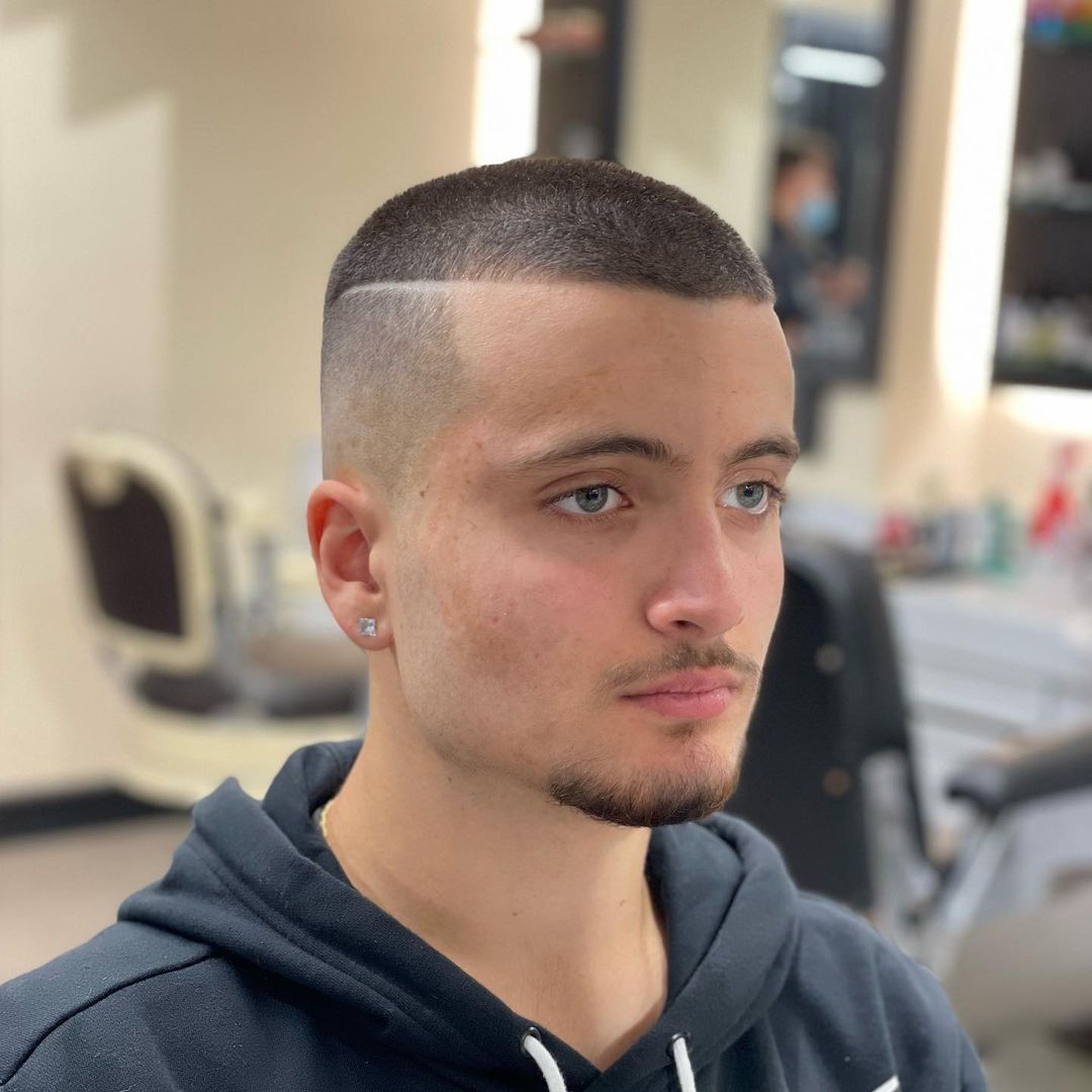 Longer top buzz haircut with shaved part