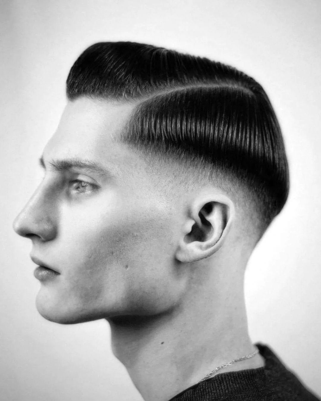 Side part hairstyle with oil-based pomade